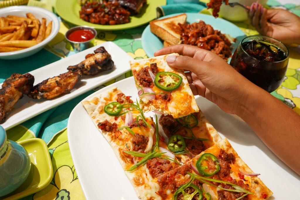 Smoked Brisket Flatbread with other dishes behind it